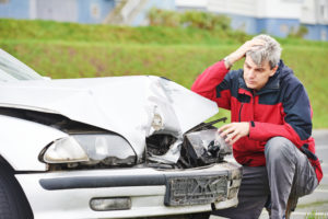 Car Accident Lawyer Tampa, FL- man looking at his wrecked car